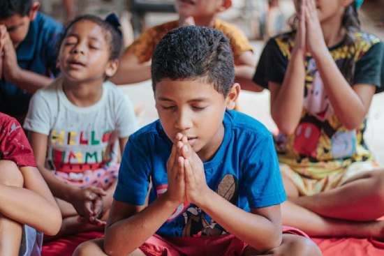 Children Praying during Sabbath School Children with hands folded and eyes closed in prayer during sabbath school