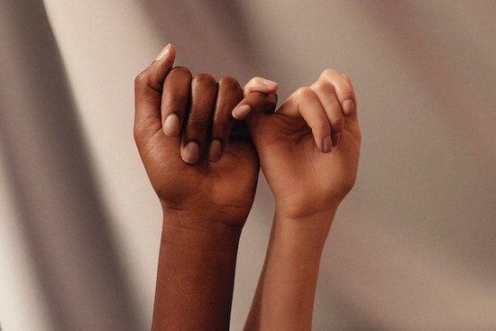 Two hands making a pinky promise, symbolizing the faithfulness of Philadelphia