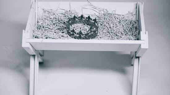 Jesus Manger A black and white image of a king's crown lying in a manger, representing the way Jesus, the King of the Universe, was placed in a humble manger at His birth.