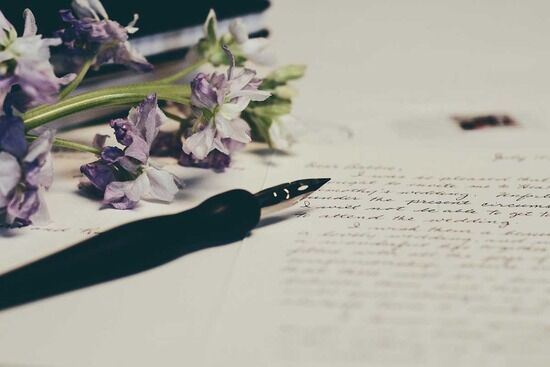 Written Paper Pen A ink pen resting on top of a letter