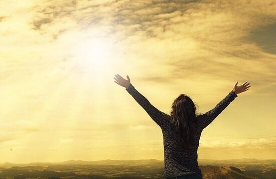 Uplifted Hands A silhouette of a woman with hands uplifted in a prayer of thanksgiving to God
