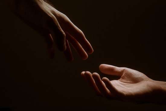 God Helping Hand A hand reaching out to hold onto another hand