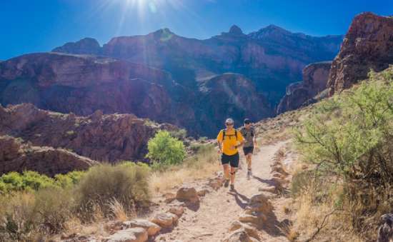 Two Men Persevering Running Two men running on a trail in the desert and demonstrating the trait of perseverance
