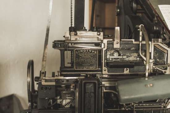 Printing Press for Publishing A linotype printer works to print manuscripts.