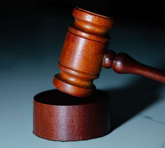 Wooden Judges Gavel A wooden gavel hitting the top of a wooden block.