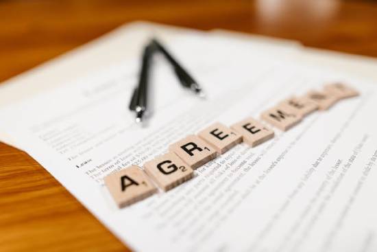 Agreement Paper with Piece of Wooden Title A lease paper with Scrabble letters spelling out the word agreement on top, representing the agreement between God and Israel.