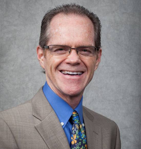 A professional headshot of Dr. Jud Lake.
