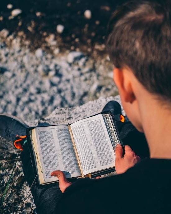 A man reading the Bible to find assurance about end-time events 