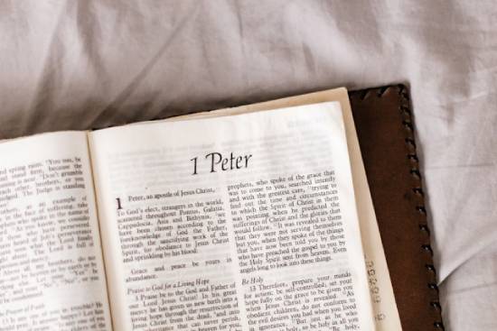 A Bible is opened to 1 Peter.