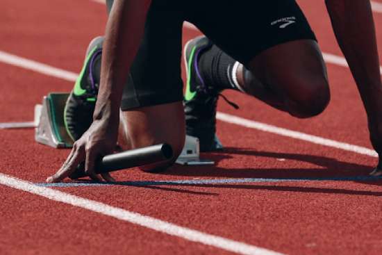 Runner athlete God giving strength to an athlete at the starting block ready to run a race