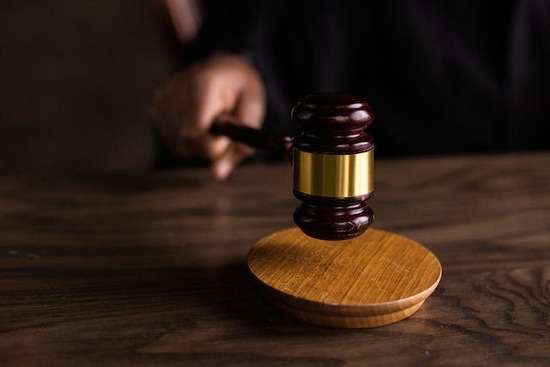 Gavel in the Hand of a Judge in Court A judge banging a gavel