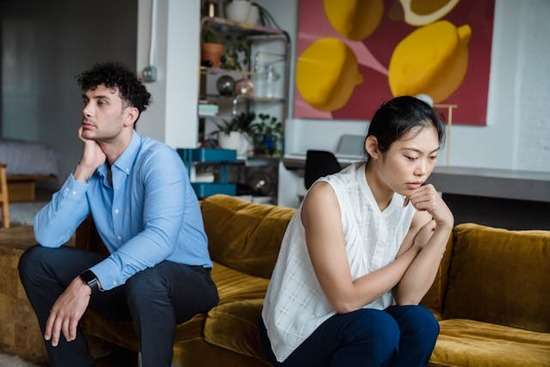 Disagreeing couple A couple looking frustrated and facing away from each other after a disagreement