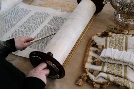 Someone reviewing an ancient scroll represents how carefully Jewish leaders in Jesus' time studied and adhered to the law of Moses.
