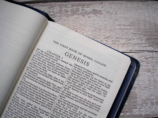 A Bible is opened to the first page of Genesis. Many believe Moses wrote the first five books of the Bible.