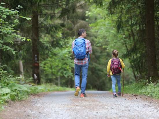 Dad and Daughter Hiking Outdoors A father and daughter hiking together and enjoying a full and healthy life