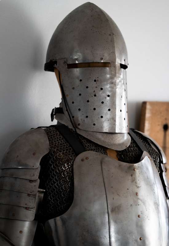 A Man Wearing The Armor A standing suit of medieval armor.
