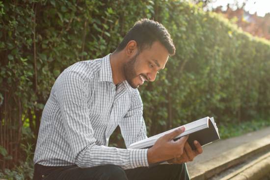 A man reads his Bible outdoors, showing that we still need to have personal time with God.