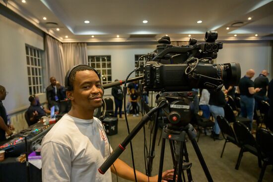 An Adventist videographer operates a video camera.